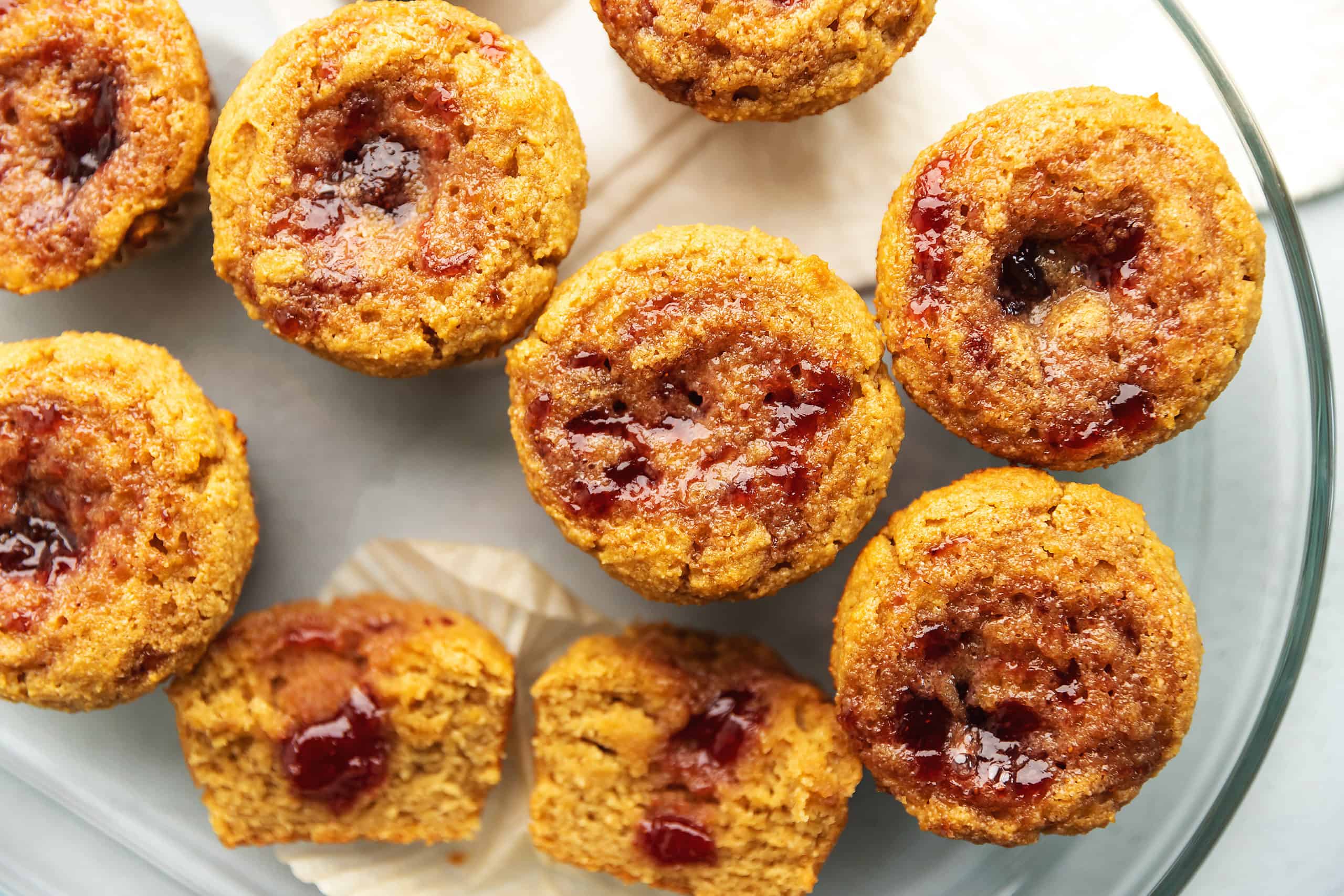 a bunch of peanut butter and jelly muffins on a plate
