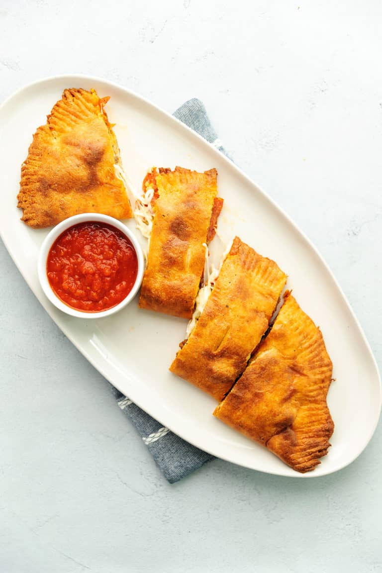 Keto meat lovers calzone on a white plate