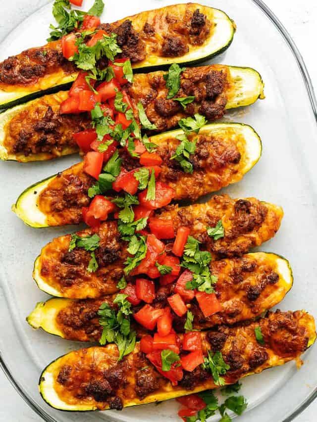keto zucchini boats on a glass plate