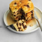 a stack of chocolate chip pancakes with syrup