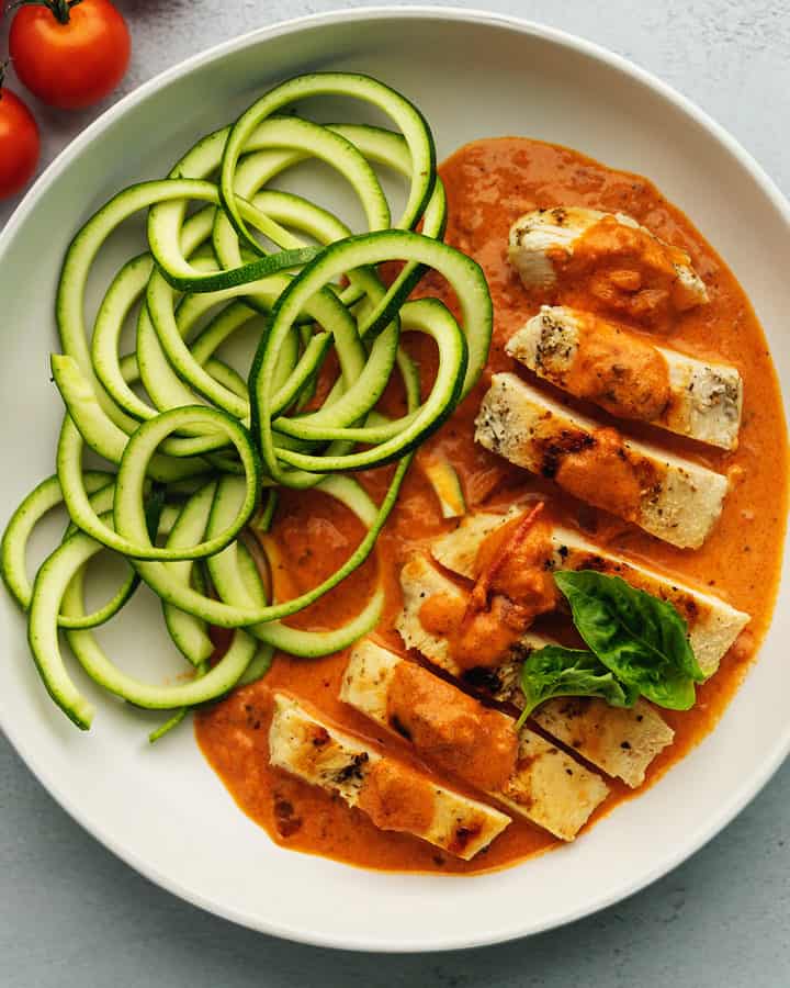 chicken and vodka sauce on a plate with zucchini noodles