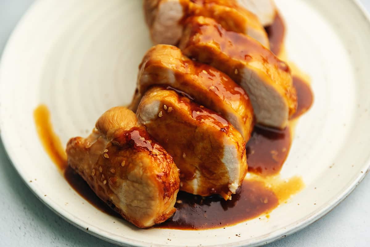 teriyaki pork tenderloin on a white plate