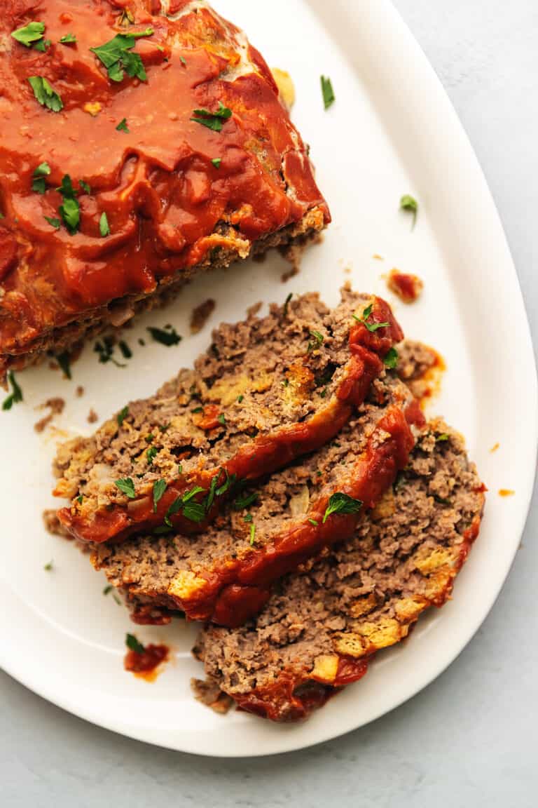 sliced keto meatloaf on a white plate