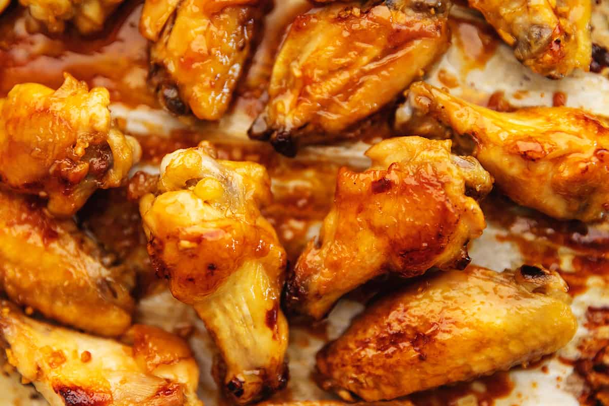 a bunch of sticky chicken wings