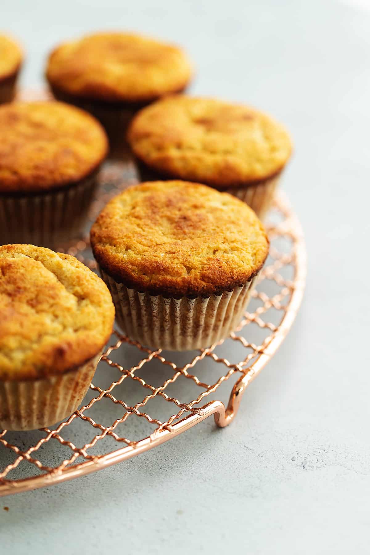 pumpkin spice muffins on a copper cooling rack