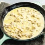 chicken breasts in a cream sauce in a skillet