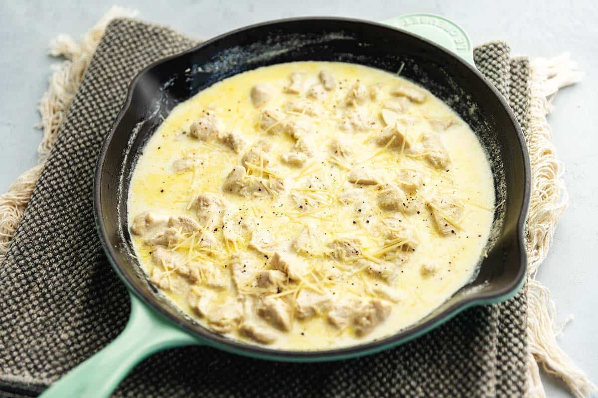 chicken breasts in a cream sauce in a skillet