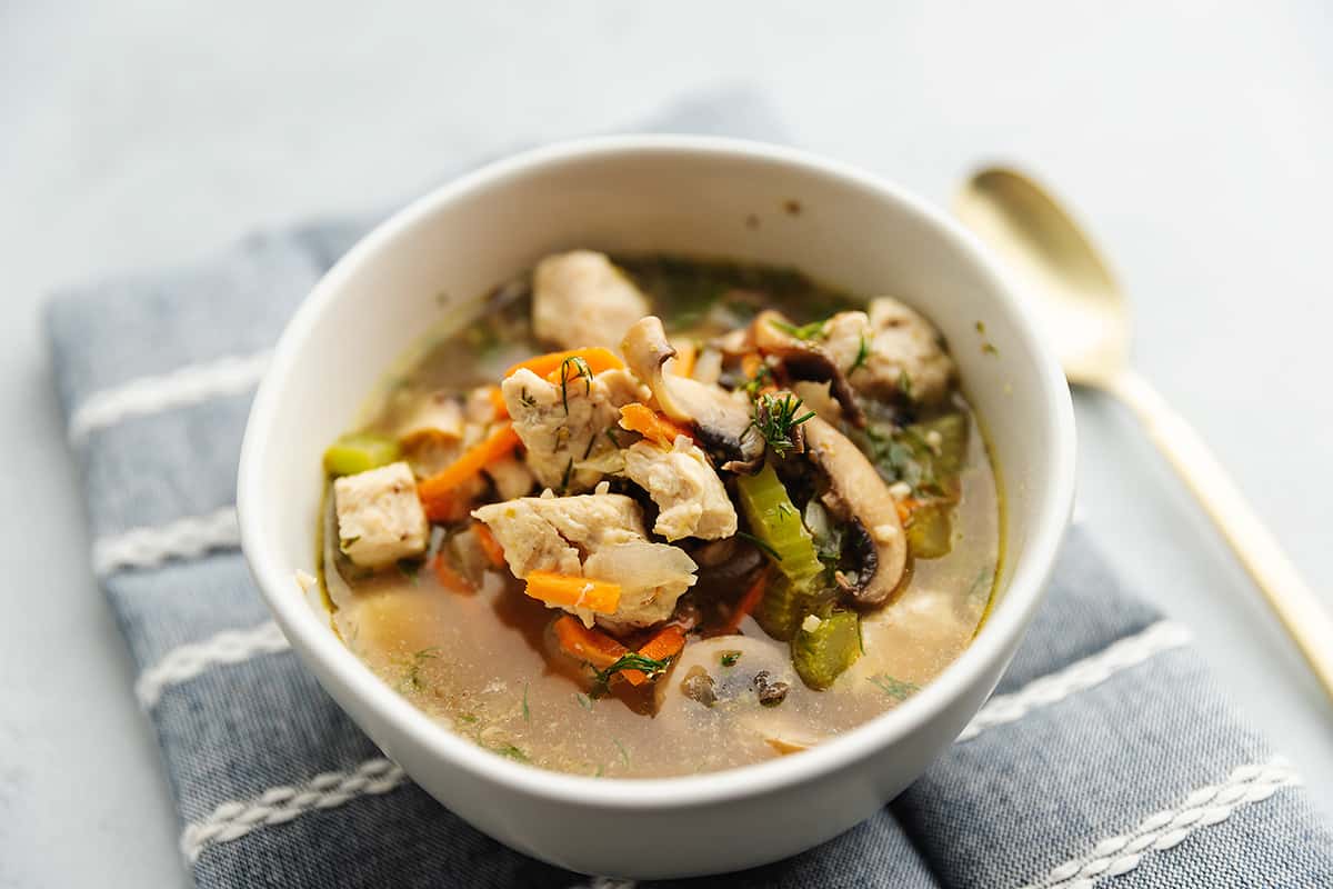 lemon chicken soup in a white bowl