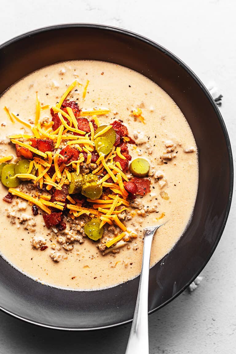 keto cheeseburger soup topped with bacon and pickles