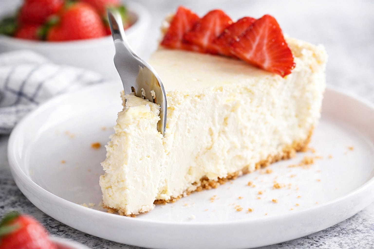 A slice of keto cheesecake on a white plate