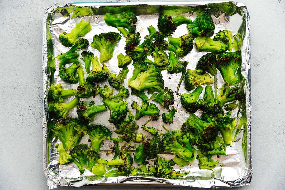 cooked broccoli on an air fryer tray