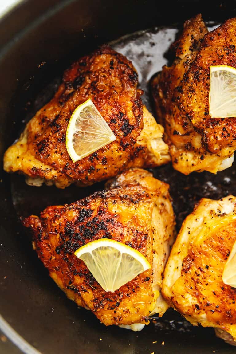 lemon pepper chicken thighs in a cast iron skillet