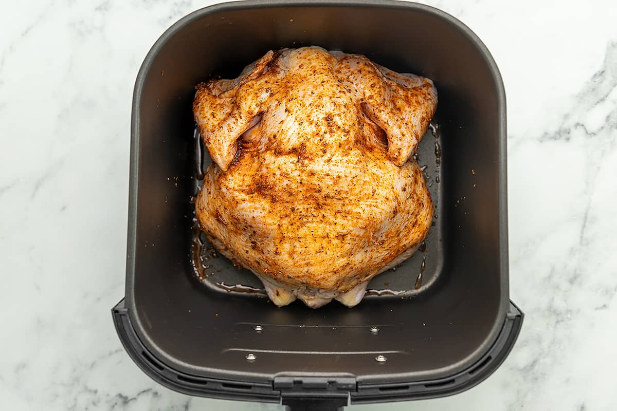 a whole chicken breast side down in an air fryer