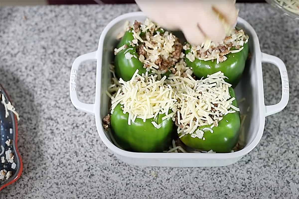 filling stuffed peppers and topping with cheese