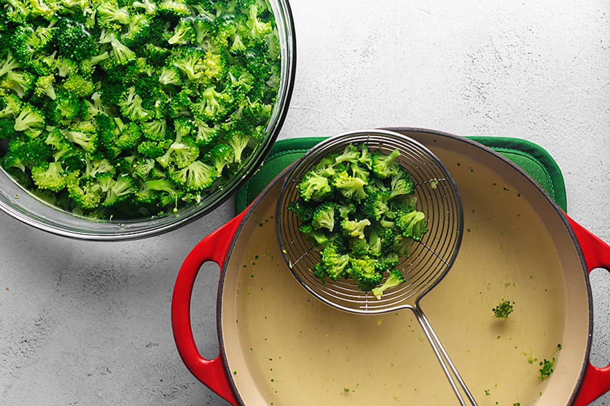 blanching broccoli in a red pot
