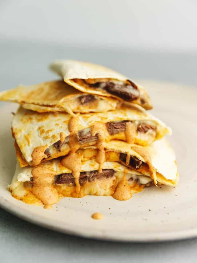 a stack of steak quesadillas on a plate