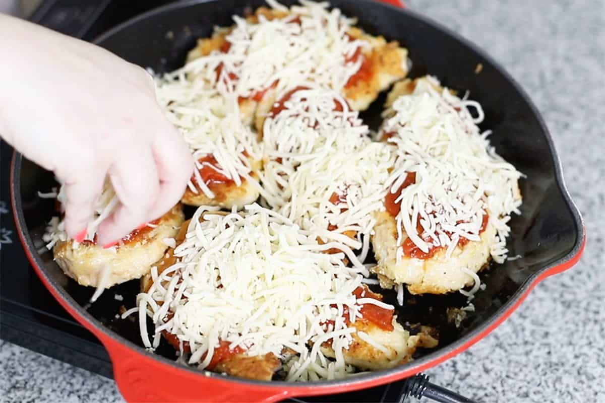 adding parmesan cheese to keto chicken parmesan