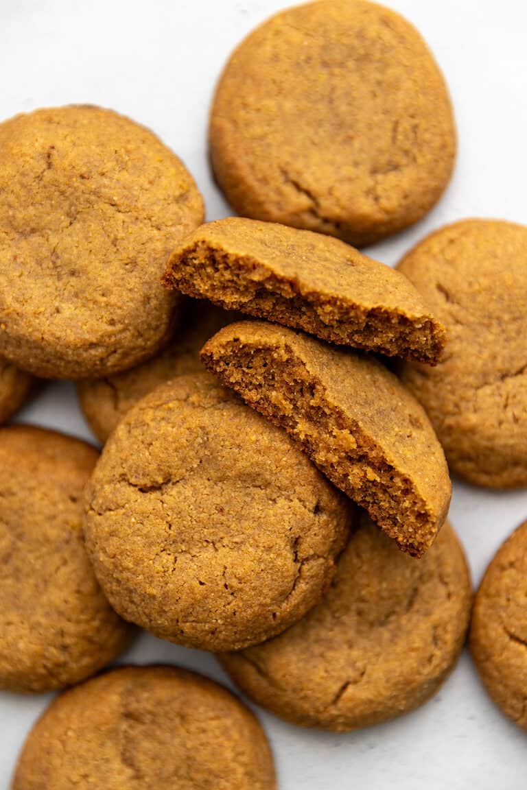 keto peanut butter cookies stacked on a light blue background