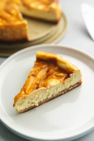 a slice of sugar free caramel cheesecake on a white plate