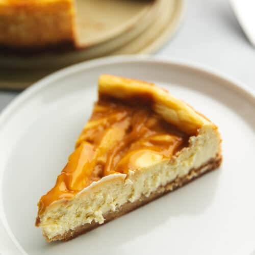 a slice of sugar free caramel cheesecake on a white plate