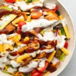 a white bowl with bbq chicken salad