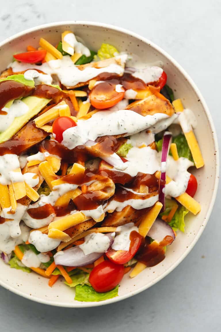a white bowl with bbq chicken salad