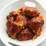 bbq chicken thighs in a white bowl