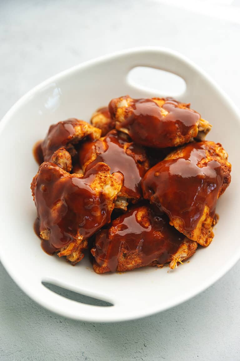 bbq chicken thighs in a white bowl