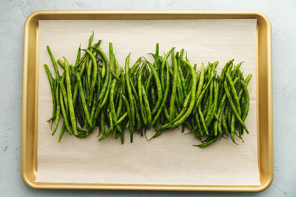 green beans piled up on a sheet tray