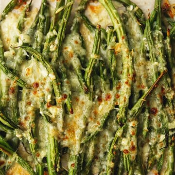 roasted green beans with cheese on a plate