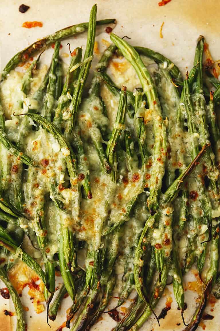 roasted green beans with cheese on a plate