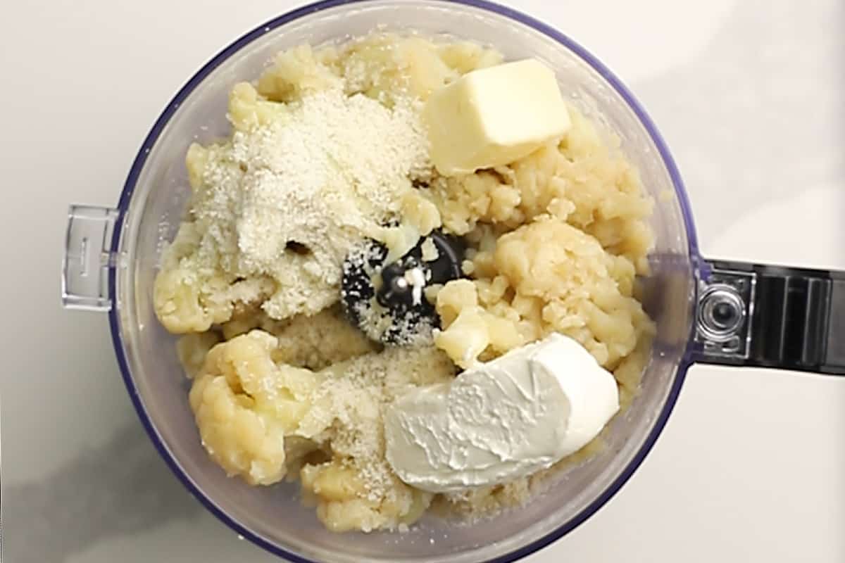 all ingredients for mashed cauliflower in a food processor