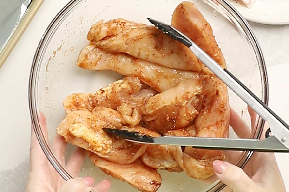 coating chicken tenders in seasoning mix