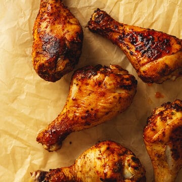 air fryer chicken legs on a piece of parchment paper