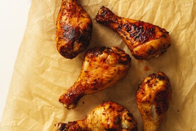 air fryer chicken legs on a piece of parchment paper