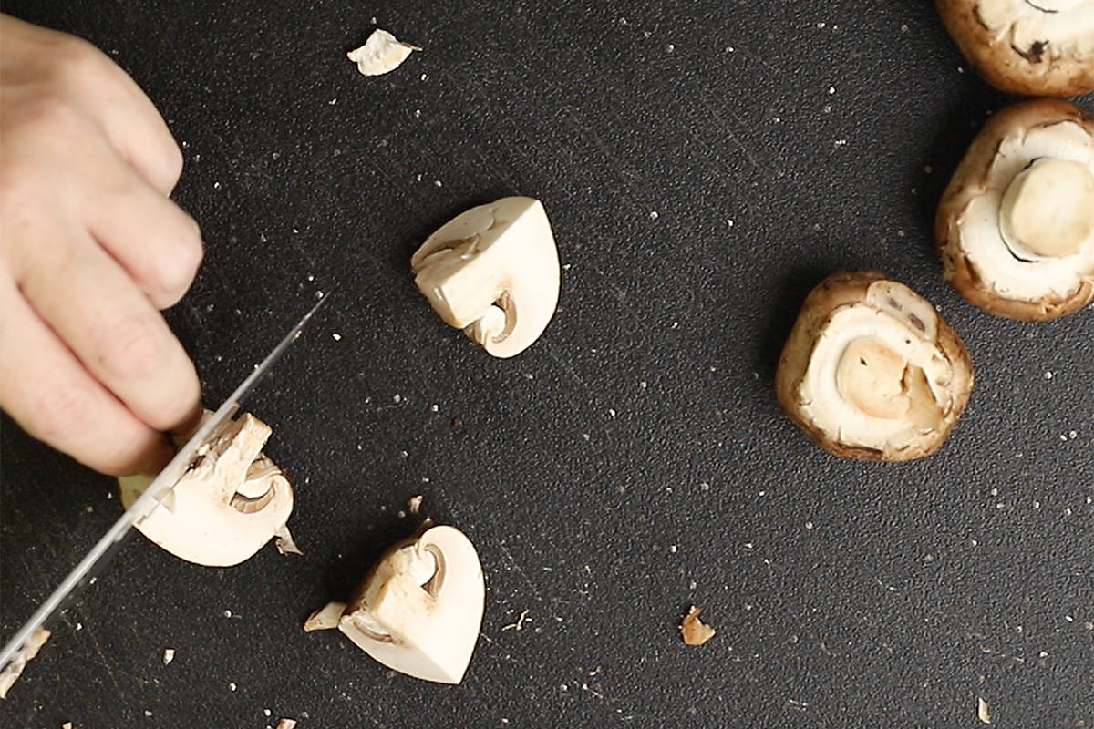 cutting mushrooms into quarters