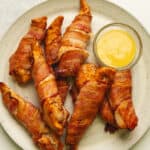 air fryer bacon wrapped chicken tenders on a plate