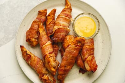 air fryer bacon wrapped chicken tenders on a plate