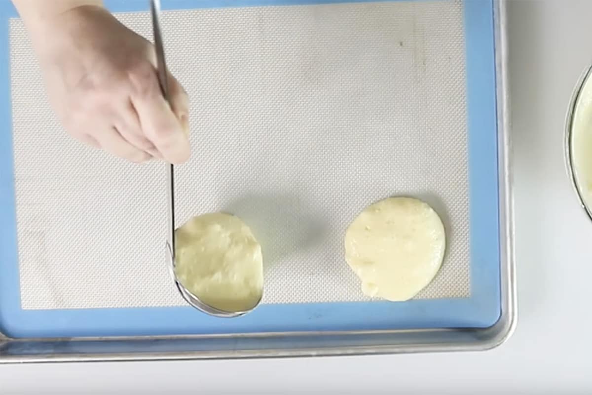 spooning cloud bread mixture onto a baking tray