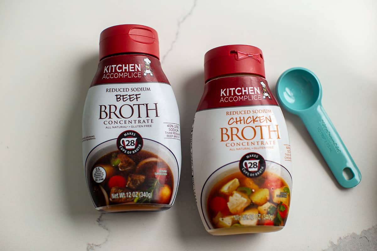 chicken and beef broth concentrate next to a measuring spoon