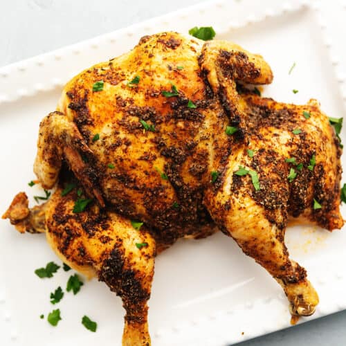 spatchcock chicken on a white platter
