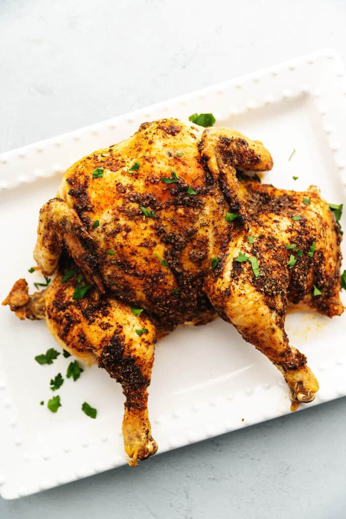 spatchcock chicken on a white platter
