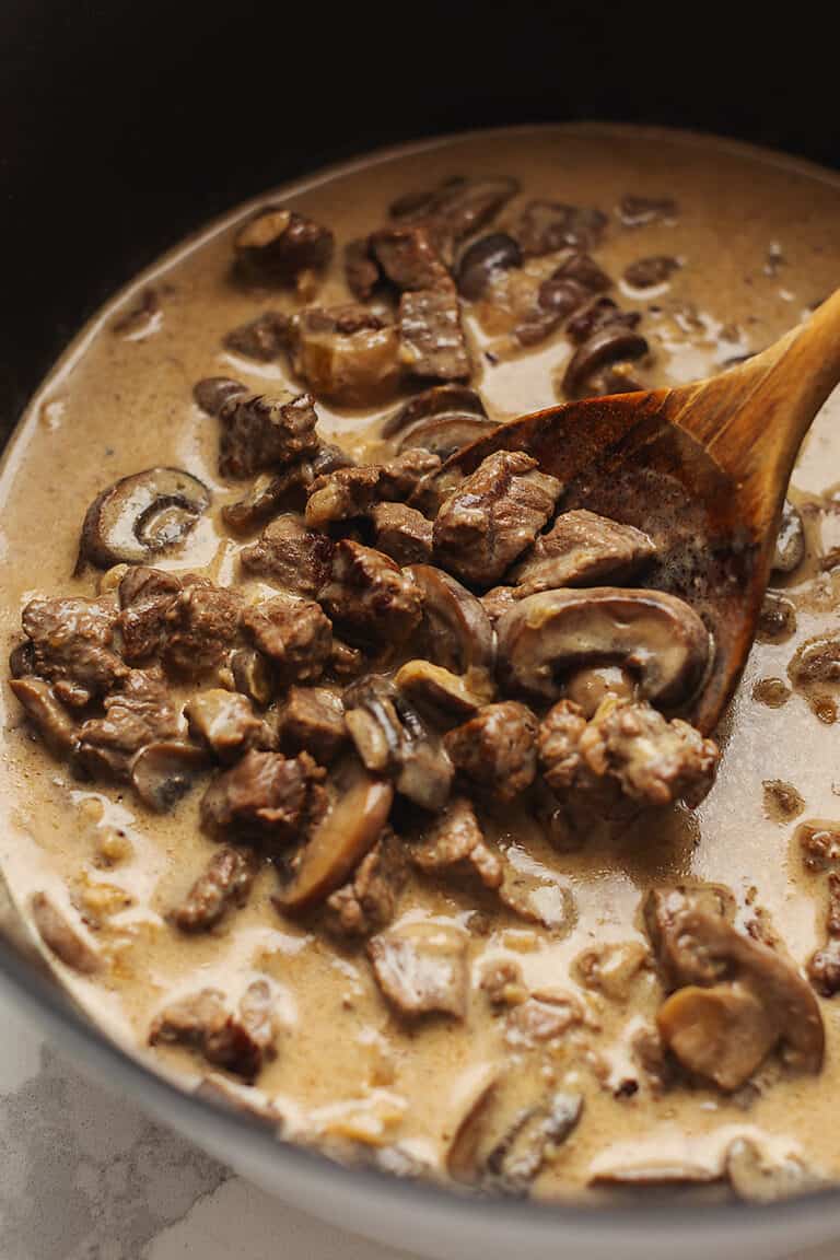 keto beef stroganoff in a pot with a wooden spoon