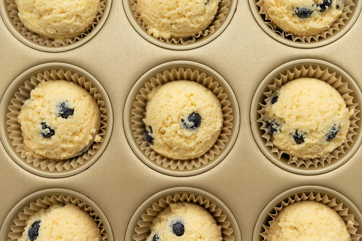 muffin batter perfectly scooped into a muffin tin