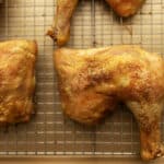 crispy baked chicken leg quarters on a wire rack