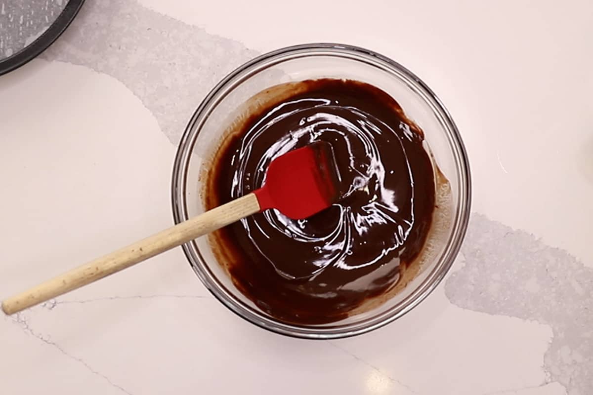 melted chocolate in a bowl with a red spatula