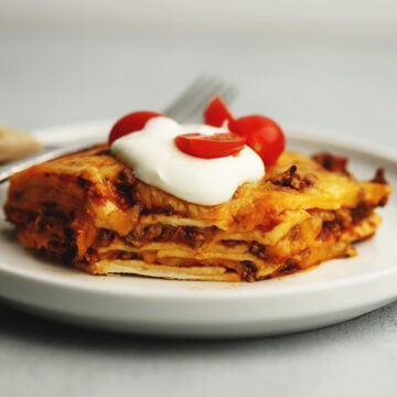mexican lasagna on a white plate