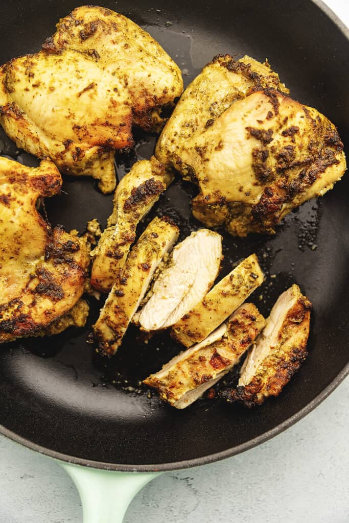 pesto chicken thighs in a cat irons skillet