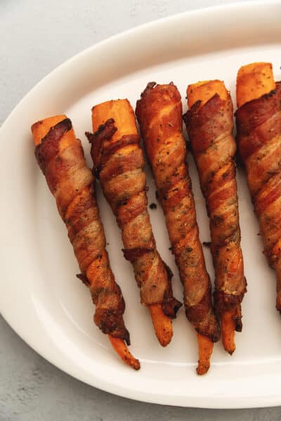 bacon wrapped carrots on a platter