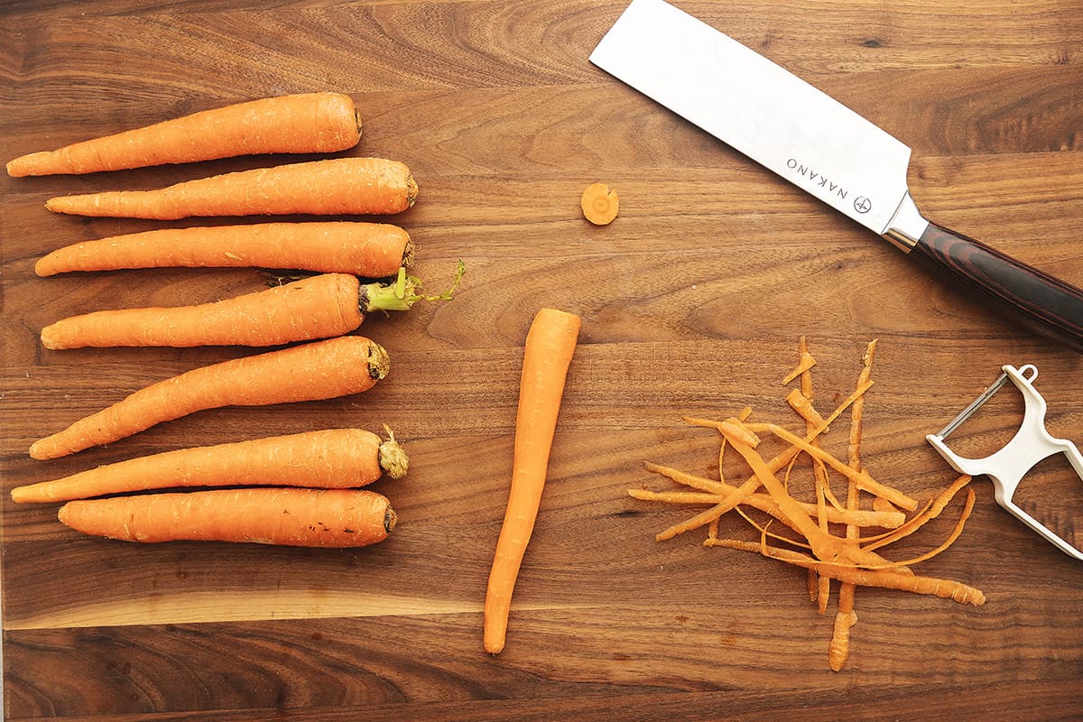 prepping carrots on a cutting board